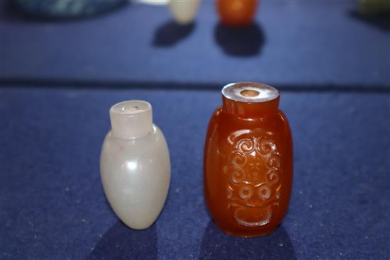 A Chinese agate snuff bottle and an amber glass snuff bottle